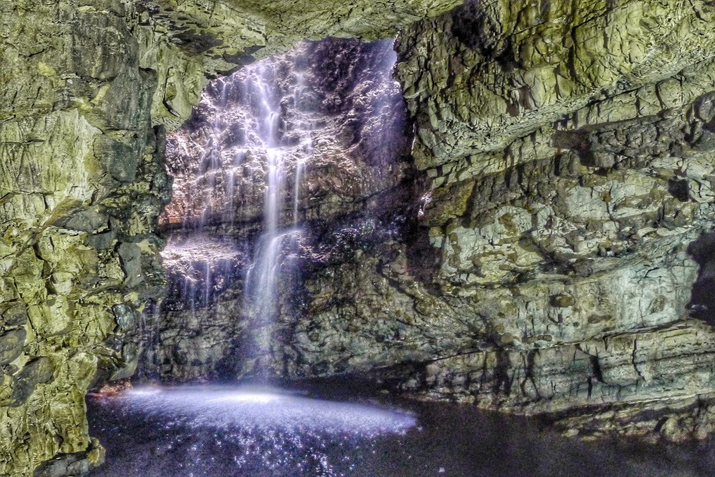 This waterfall I'd helping enlarge a blowhole inside the Smoo Cave. The colors are strange because the camera was tricked the fluorescent and natural light sources.