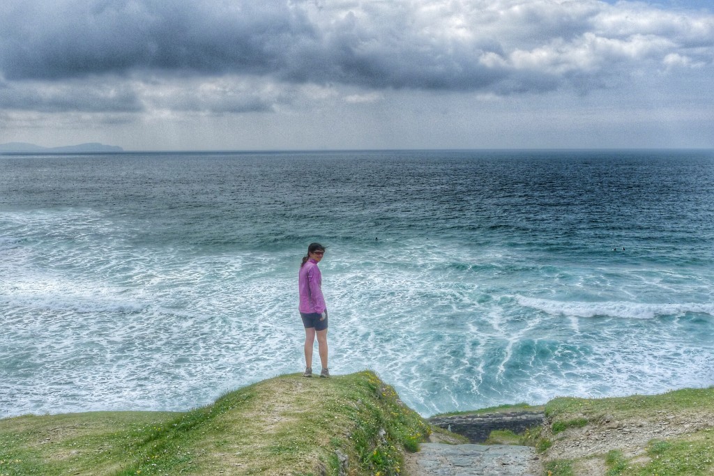 Carrie stands before the vast Atlantic on a cliff along the Dingle Peninsula.