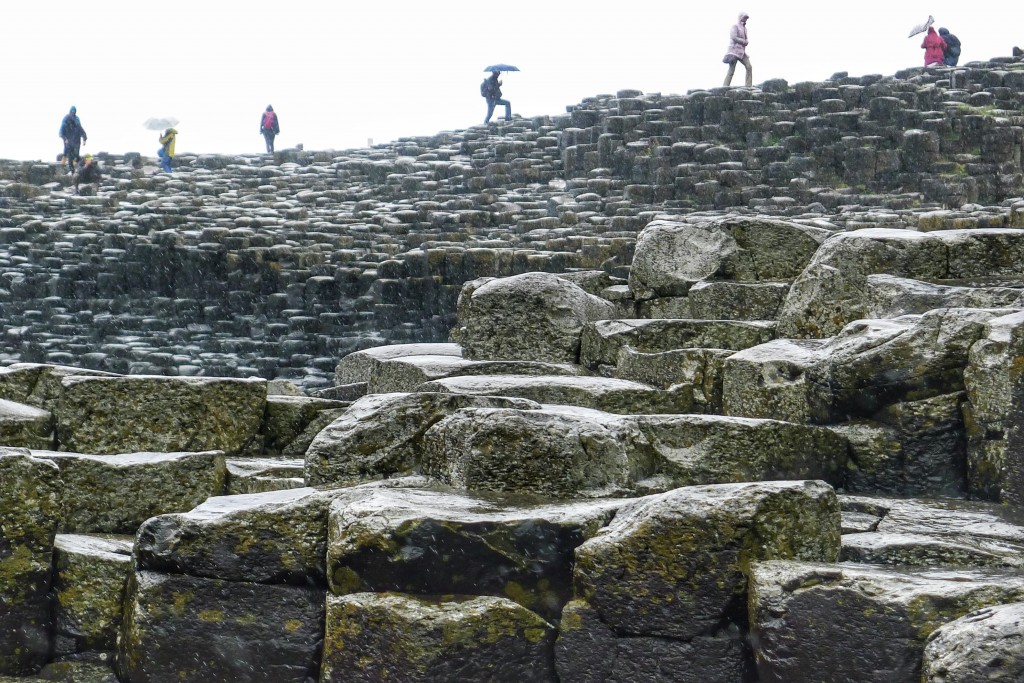 Tourists clamor over the slippery rocks at the Giant's Causeway.